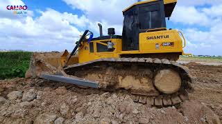 Nice view of SHANTUi Bulldozer operator expert pushing dirt , dump truck unloading dirt fill up land