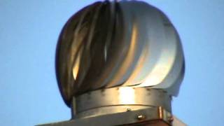 Stainless steel spinning chimney cowl fitted to a square chimney pot.