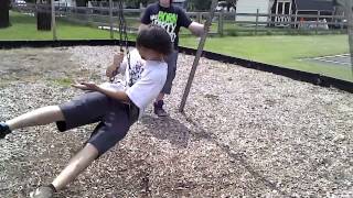 Kid pinches his thumb in swings at \