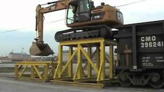 CAT 319D LN climbing onto rail car (fast motion)