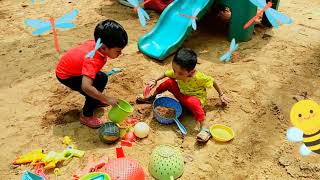 Kids playing in sand with sand toys/school ground / park /playarea /childrens playing in muddy area