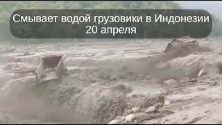 Мощные потоки смывают грузовики водой в Индонезии