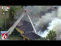 Firefighters douse burning building in Orange County