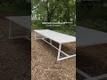 white banqueting metal patio table with reclaimed scaffold boards