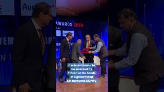 N.R. Narayana Murthy touches the feet of Ratan Tata as a mark of respect.