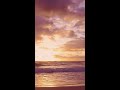 beach sunset with waves splashing 4k vertical video format relaxing nature