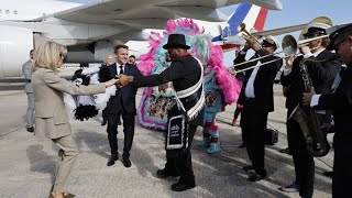 Emmanuel Macron tours New Orlean's French Quarter and is welcomed by locals