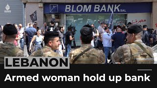 Lebanon economic crisis: Armed woman and activists hold up a bank