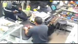 New York shopkeeper chases armed robber with machete - CCTV video