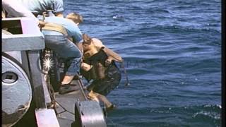 The crew of a U boat comes aboard a destroyer escort in the Atlantic Ocean during...HD Stock Footage