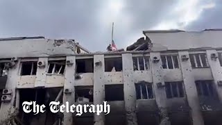 Video appears to show Russian troops raising flag on Mariupol town hall building