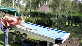 Outdoor pool table playing on cabin. Biljardia mökillä ulkona.