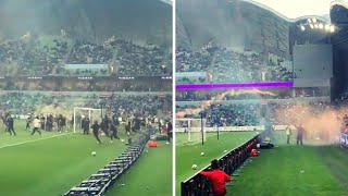 Melbourne Victory fans storm the pitch in protest to the A-league moving Grand Finals to Sydney.