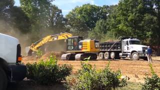 Cat 316E excavator loading dirt.