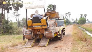 MITSUBISHI BD2G Bulldozer Driving Onto Trailer And Pushing Dirt to Construct New Road In The Village