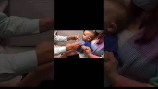 Doctor distracts baby from her shots with goofy tune...