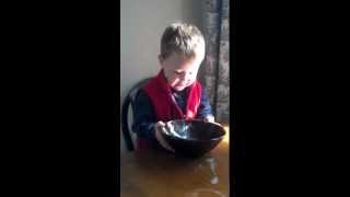 Elias drinking milk from a bowl