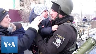 Ukrainian Police Officer Says Goodbye to Distraught Son as Family Flees Irpin