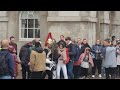 Guard pushes female tourist out of the way. make way  for The kings life Guard  (slow motion)