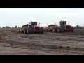 Two Versatile 500 Tractors pulling tandem Weyco 2250 XTR II pan scrapers.