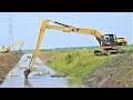 Long Reach Excavator Digging Clearing Mud From The Canal CAT 320D L Komatsu PC200 Kobelco SK200