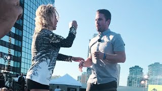 Emily Bett Rickards filming Stephen Amell with a fan's phone @ SYFY #SDCC2017