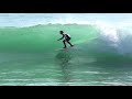 surfers ride shorebreak at praia da mareta